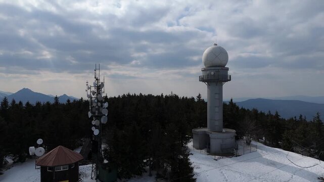 Title: Aerial view of weather radar station and telecommunication towers on mountain top