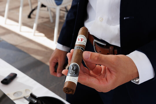 Businessman holding a fine cigar celebrating an anniversary