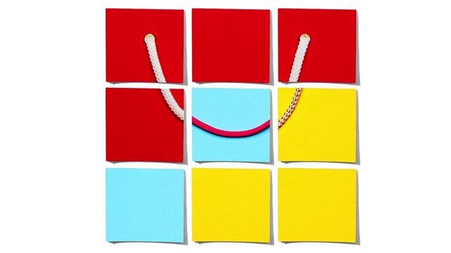 Bright shopping bags animation with sticky notes revealing drop incoming message. Concept of product drop announcement, hype marketing, ecommerce launch and creative stop motion advertising.