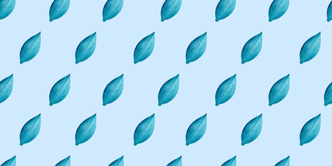 Lush emerald tree leaves drift in a diagonal rhythmic motion across a light blue background, watercolor seamless pattern for organic textile prints and packaging with natural inspiration. © Tetiana