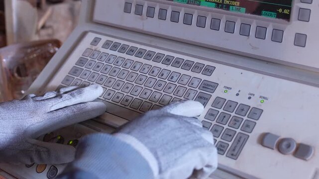 Worker Operating Industrial Machine Control Panel Keyboard in Factory
