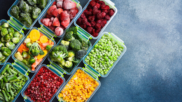 Background of frozen vegetables and fruits. Variety of frozen food for the winter. Top view. Free space for text.