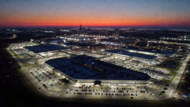Aerial View of Industrial Complex at Dusk with Vibrant Sunset Sky