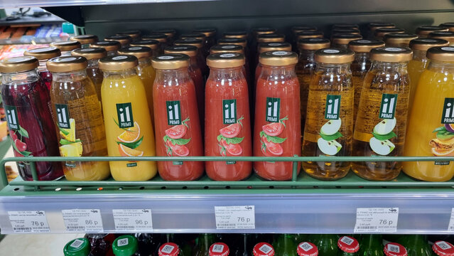 Colorful fruit juice bottles on supermarket shelf