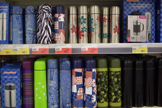 Colorful thermos bottles arranged on store shelf
