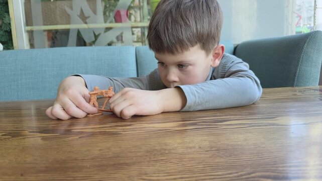 Child engaged in roleplay game with toy soldiers. Creative storytelling and imagination development. Suitable for childhood, creativity and education content.