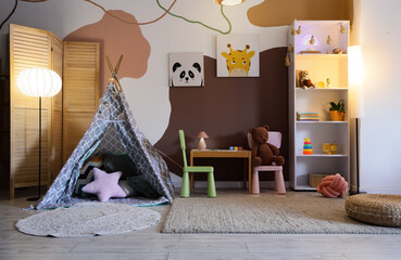 Interior of children's room with play tent, toys and glowing lamps © Pixel-Shot