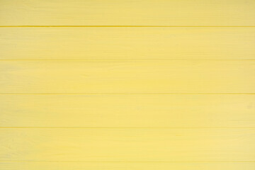Naklejka premium Yellow painted wooden texture as background, top view