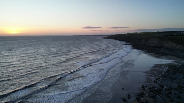 4K Flying‑Into‑the‑Bay Aerial Drone Shot of Dunraven Bay at Sunset Featuring the Coastline