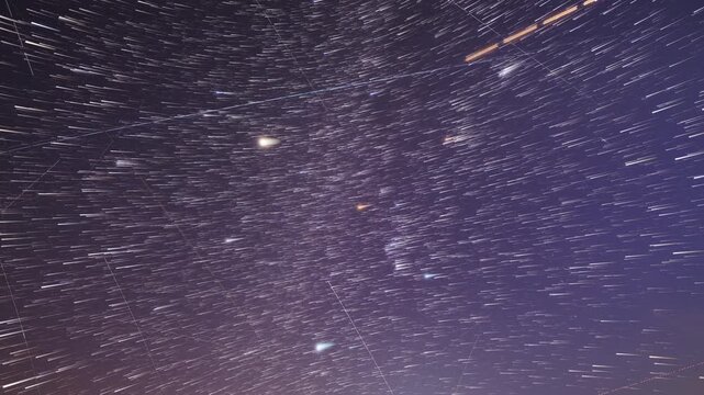 Orion constellation startrails with airplane and satellite trails. Time-lapse video.