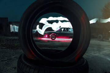 drift powerful car in an old body with black extension and bottom lighting night photography with long exposure © yurii oliinyk