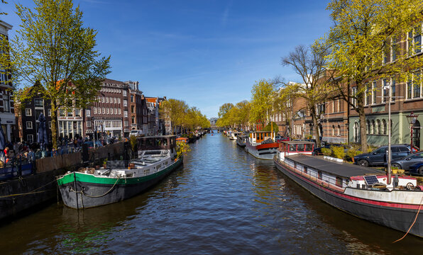 Traditional houseboats (woonboten) line one of Amsterdam's historic canals in the Netherlands.