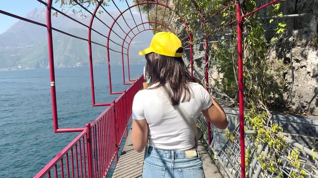 Rear View Woman Walking in Charming Streets of Lake Como, Italy, Scenic Travel Lifestyle with Beautiful Lake Views and European Architecture