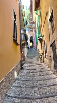 Vertical video of colorful narrow streets in Riomaggiore, Cinque Terre, with pastel houses and picturesque Italian architecture, vibrant travel destination in Europe