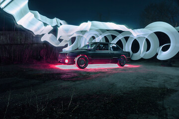 drift powerful car in an old body with black extension and bottom lighting night photography with long exposure © yurii oliinyk