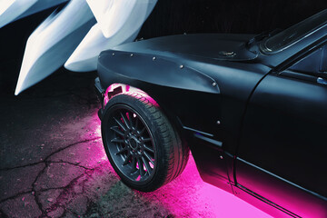 drift powerful car in an old body with black extension and bottom lighting night photography with long exposure © yurii oliinyk