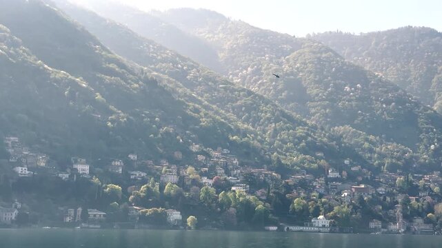 Scenic Lakeside Villages of Lake Como Surrounded by Green Mountains, Italy Travel Destination Landscape Viewed from the Water