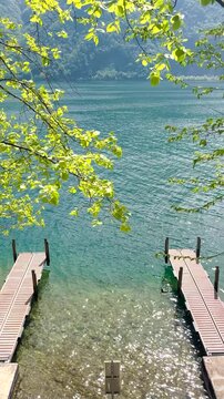 Calm Lake with Small Pier and Boats, Peaceful Forest Nature Landscape, Relaxing Background for Travel, Wellness, Meditation