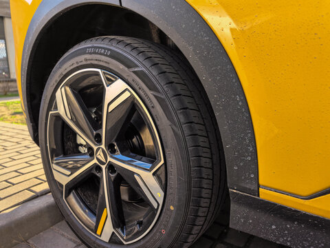 Close-up of Modern Yellow SUV Car Wheel and Fender