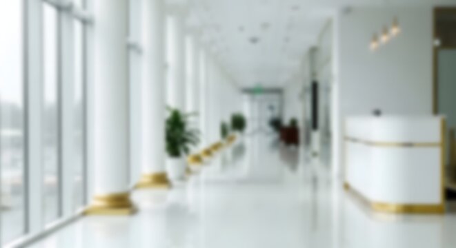 A bright and modern hospital corridor with blurry figures emphasizing cleanliness and sterile environment