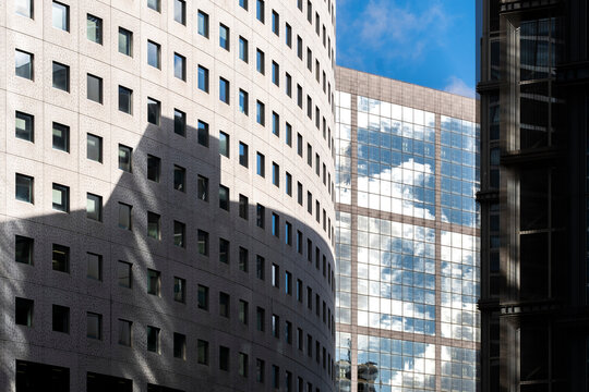 Curved facade architecture for business finance in urban Paris La Defense with modern glass curvature and reflective lines across the building