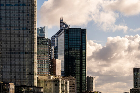 Late afternoon skyscraper skyline architecture for business finance in urban glass towers under clouds over Paris La Defense in France