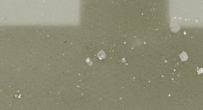 Close-up of sugar cubes dissolving in water with light reflections.