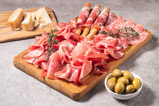 Charcuterie board. Antipasti appetizers of meat platter with salami, prosciutto crudo or jamon and olives.