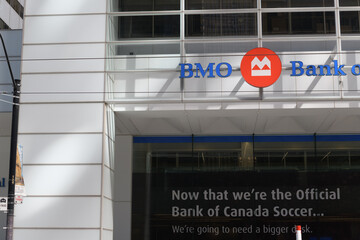 Naklejka premium Bank of Canada Soccer sign and exterior building facade and sign of BMO Financial Group, located at First Canadian Place, 100 King St W, Toronto