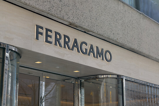exterior building and sign of Ferragamo, a brand name shop offering iconic Italian footwear, silk, leather goods, located at 108 Bloor St W, Toronto
