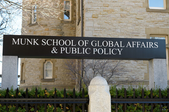 defocused sign of Munk School of Global Affairs and Public Policy located at 1 Devonshire Pl (seen from Bloor St W), University of Toronto