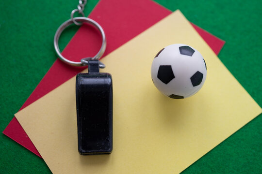 Red and yellow cards with a whistle and soccer ball
