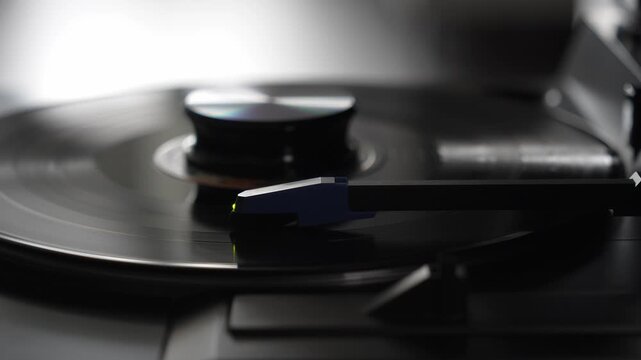 Stylus needle playing spinning vinyl record on turntable, analog music concept   