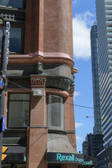 Obraz premium heritage building corner and signs outside Rexall, a drug store chain, located here at 159 Yonge St, Toronto