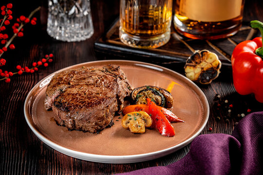 Grilled beef steak with vegetables and whiskey