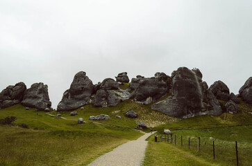 Centered pathway leading to limestone formations at Castle Hill Kura Tawhiti Conservation Area, Canterbury Region, New Zealand © apiwit