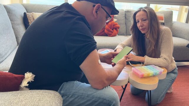 Pareja usando gluc&oacute;metro inteligente con m&oacute;vil pantalla verde