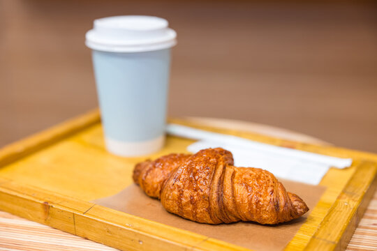 Cozy cafe moment with coffee and croissant