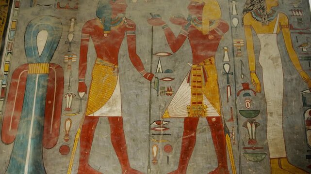 KV16 royal tomb of Ramesses I, Valley of the Kings, Luxor, Egypt, depicting processions of gods, mummiform figures and hieroglyphics on grey and golden walls.