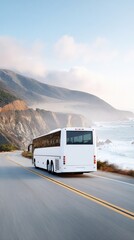 Obraz premium White coach bus driving along winding coastal highway