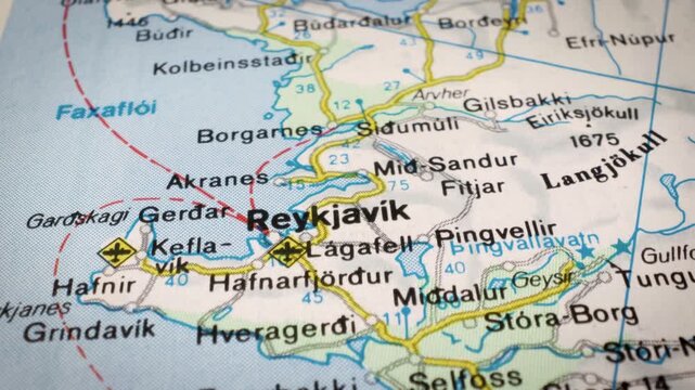 Sliding camera movement over Iceland road map toward Reykjavik, macro travel concept