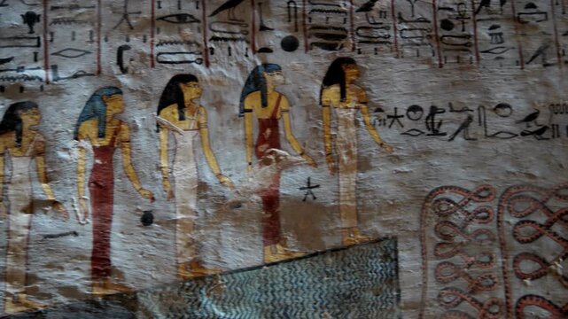 KV16 royal tomb of Ramesses I, Valley of the Kings, Luxor, Egypt, depicting processions of gods, mummiform figures and hieroglyphics on grey and golden walls.