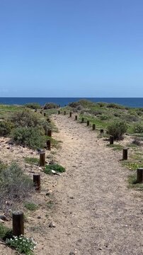 Sandy coastal path through dunes leading to the ocean   beach in El Medano, Tenerife, Canary Islands,Spain,4K.
