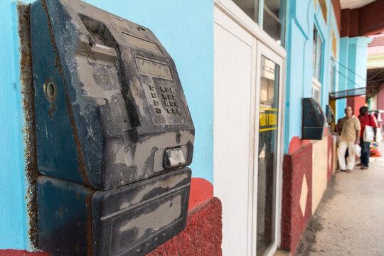 Cuba, Havana.  Old broken payphone on the side of the street in Old Havana
