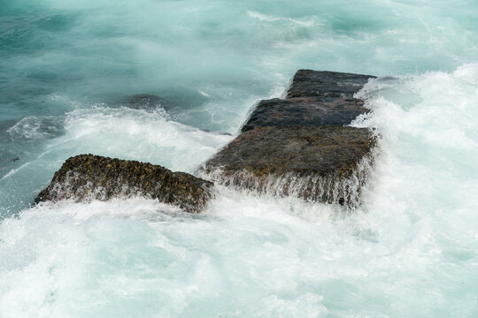 Cuba, Havana.  Old blocks of stone in the harbour, serving as a breakwater along side of the Malec&oacute;n.
