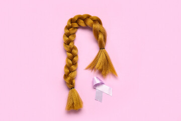 Naklejka premium Braided red hair for donation with purple awareness ribbon on pink background