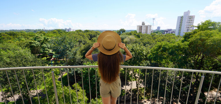 Visiting Mato Grosso, Brazil. Panoramic view of traveler girl on Cuiaba belvedere, Mato Grosso, Brazil.