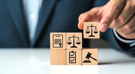 Naklejka premium Legal justice concept with wooden blocks, lawyer holding scale of justice icon, law firm services and attorney advocacy symbols on wood cubes