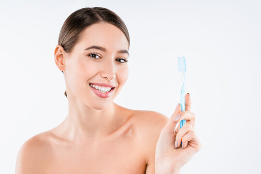 Beauty portrait of cheerful young woman holding toothbrush isolated on white background, dental care, oral hygiene, healthy smile, morning routine and wellness concept