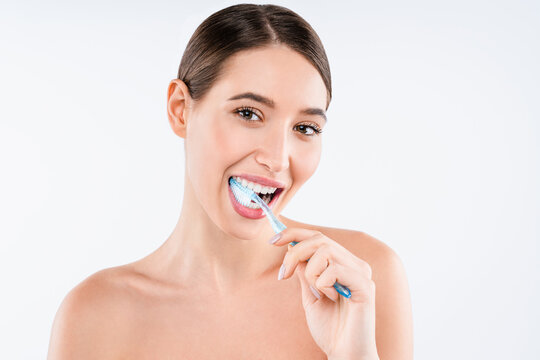 Happy young woman cleaning teeth with toothbrush isolated on white background, oral hygiene, dental care, fresh breath and wellness lifestyle dentistry concept